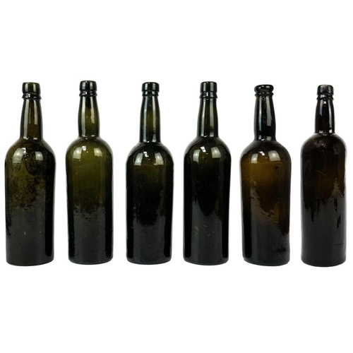 410 - Six assorted green glass wine bottles. Late 18th and 19th century, height 29cm.