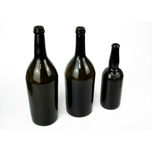 411 - A green glass magnum wine bottle, circa 1820. With kick-up base, height 35cm, another similar magnum... 