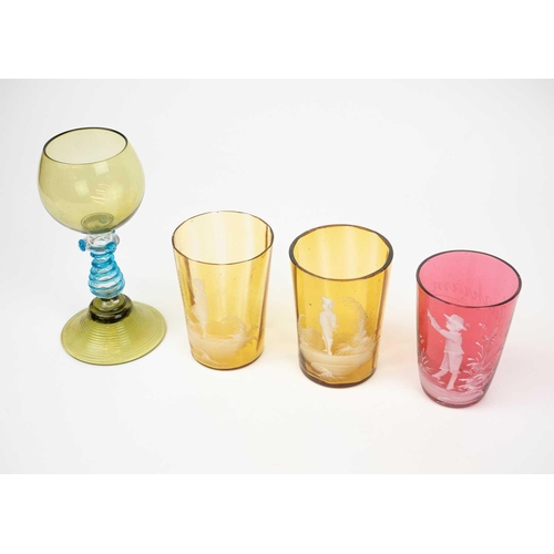 418 - A pair of amber Mary Gregory glass beakers. Height 9.5cm, together with a cranberry example, a small... 