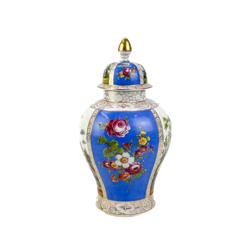 483 - A pair of German porcelain baluster vases and covers. Decorated on blue ground with panels of courti... 