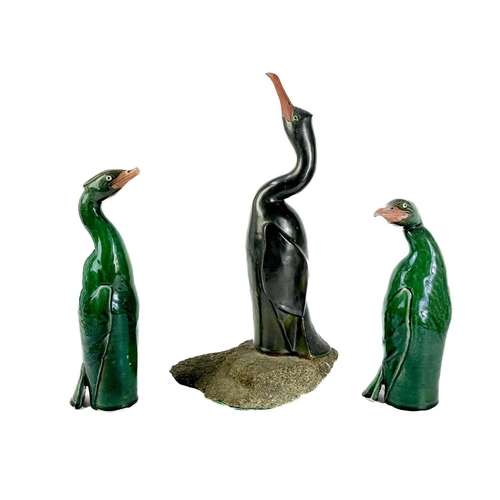 486 - Humfrey Wakefield - A pottery cormorant on stone stand. With HW seal mark. Height 39cm. Together wit... 