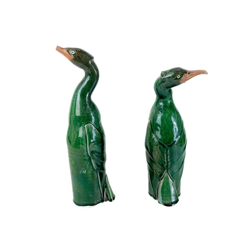 486 - Humfrey Wakefield - A pottery cormorant on stone stand. With HW seal mark. Height 39cm. Together wit... 