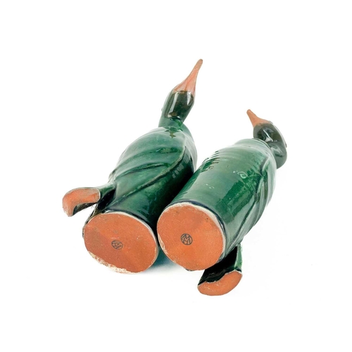 486 - Humfrey Wakefield - A pottery cormorant on stone stand. With HW seal mark. Height 39cm. Together wit... 