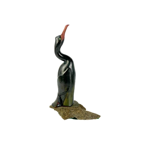 486 - Humfrey Wakefield - A pottery cormorant on stone stand. With HW seal mark. Height 39cm. Together wit... 