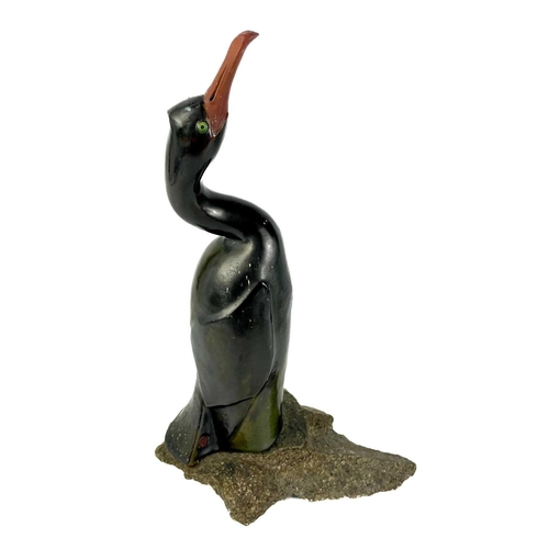 486 - Humfrey Wakefield - A pottery cormorant on stone stand. With HW seal mark. Height 39cm. Together wit... 