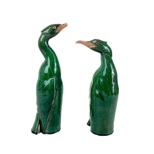 486 - Humfrey Wakefield - A pottery cormorant on stone stand. With HW seal mark. Height 39cm. Together wit... 