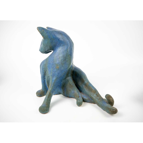 489 - A glazed blue ceramic cat figurine. Height 29cm. Together with seven other various feline figurines.
