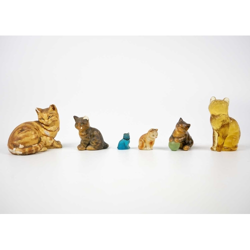489 - A glazed blue ceramic cat figurine. Height 29cm. Together with seven other various feline figurines.