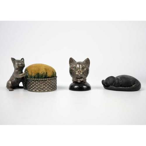 491 - A Tony White cat ceramic figurine. Height 27cm. Together with a pin cushion metal cat figurine and t... 