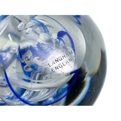 494 - A Langham England paperweight. In swirling blues and whites. Together with 2 other paperweights and ... 