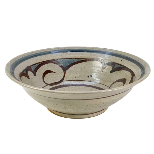 516 - A large pottery jug. Height 32cm together with two other pottery jugs and a large studio pottery dis... 