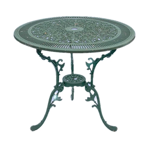 518 - A green painted metal bistro set. Comprising a circular table, height 68.5cm, diameter 80cm, and fou... 