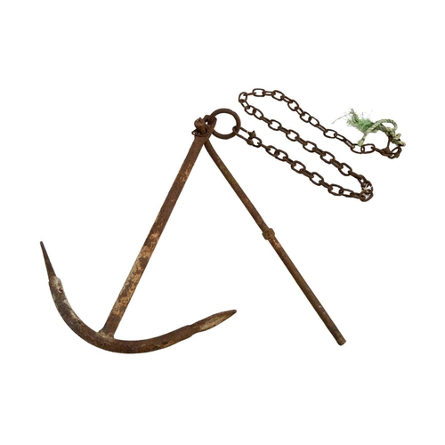 521 - A wrought iron ship's anchor. With chain, height 82cm, width 57cm.