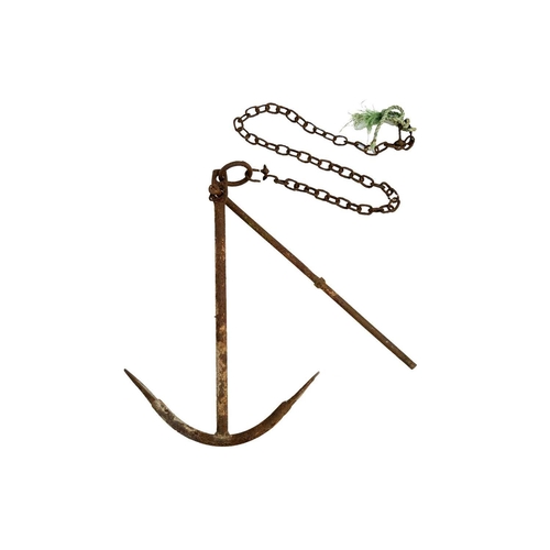521 - A wrought iron ship's anchor. With chain, height 82cm, width 57cm.