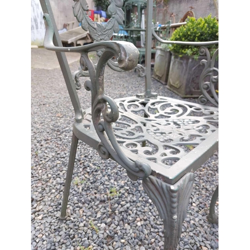 522 - A green painted metal bistro set. Comprising a circular table, height 68.5cm, diameter 80cm, and fou... 