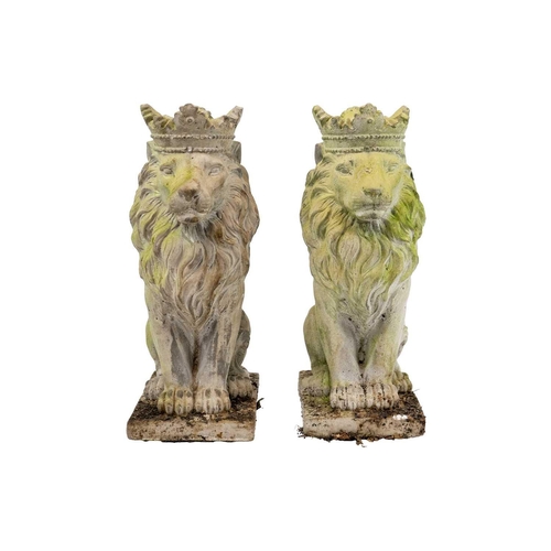 524 - A pair of reconstituted stone sculptures of seated lions wearing crowns. Height 35cm.