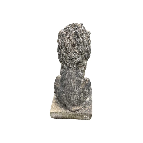 528 - A cast reconstituted stone statue of a seated lion. Raised on square base. Height 85cm.