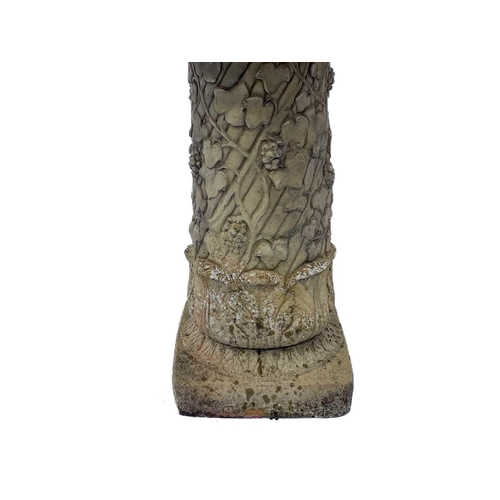 530 - A cast reconstituted stone birdbath. Raised on fruiting vine pedestal. Height 70cm, diameter 56cm.