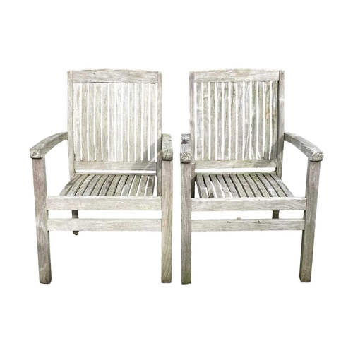 533 - A large circular weathered teak garden table. With polished granite Lazy Susan, diameter of top 180c... 