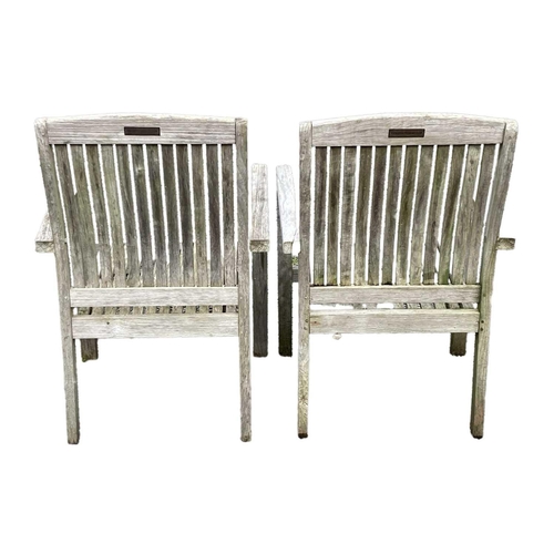 533 - A large circular weathered teak garden table. With polished granite Lazy Susan, diameter of top 180c... 