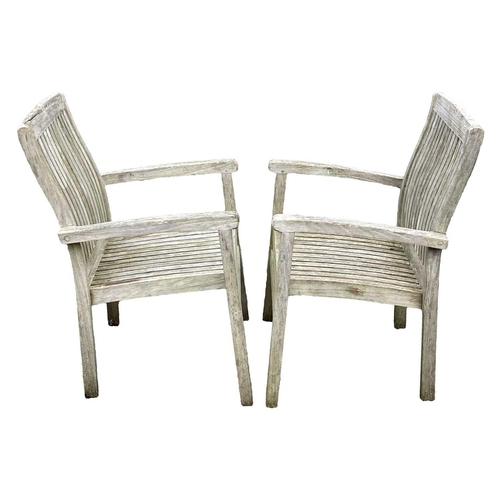 533 - A large circular weathered teak garden table. With polished granite Lazy Susan, diameter of top 180c... 