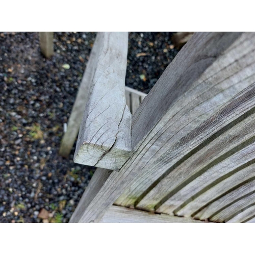 533 - A large circular weathered teak garden table. With polished granite Lazy Susan, diameter of top 180c... 