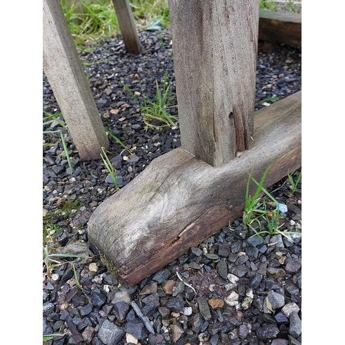 533 - A large circular weathered teak garden table. With polished granite Lazy Susan, diameter of top 180c... 