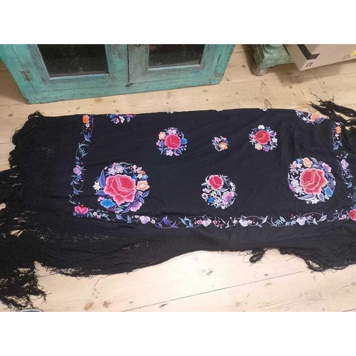 100 - A Chinese embroidered black silk shawl, 20th century. With polychrome embroidered flowers, foliage a... 