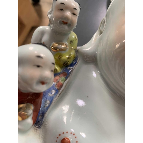 11 - A large Chinese porcelain model of Buddha, 20th century. With five boys and oval seal mark to base, ... 