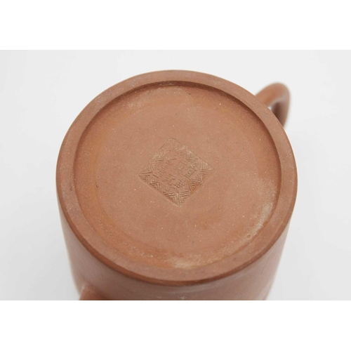 122 - A Chinese Yixing teapot. Seal mark, height 11cm, width 17cm, diameter 9.5cm.