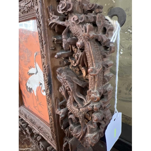 124 - A Chinese carved wood photo frame, early 20th century. Carved with dragons, birds, animals, pagodas ... 