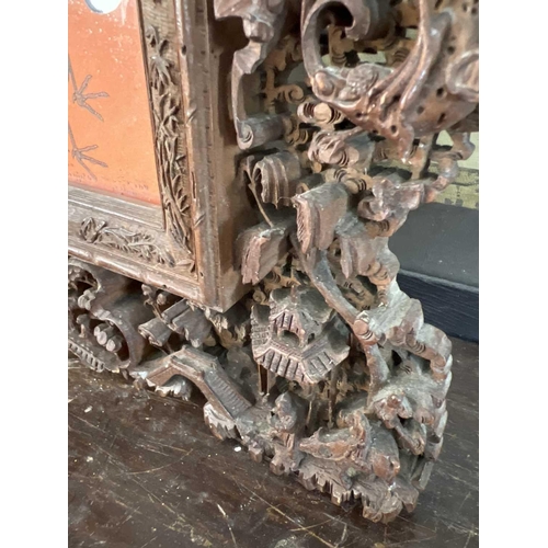 124 - A Chinese carved wood photo frame, early 20th century. Carved with dragons, birds, animals, pagodas ... 