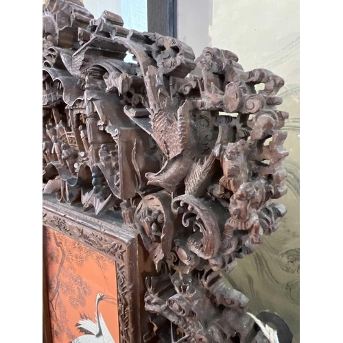 124 - A Chinese carved wood photo frame, early 20th century. Carved with dragons, birds, animals, pagodas ... 