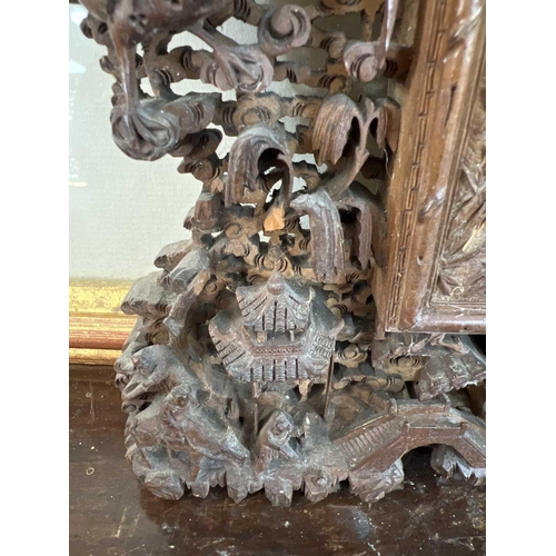 124 - A Chinese carved wood photo frame, early 20th century. Carved with dragons, birds, animals, pagodas ... 