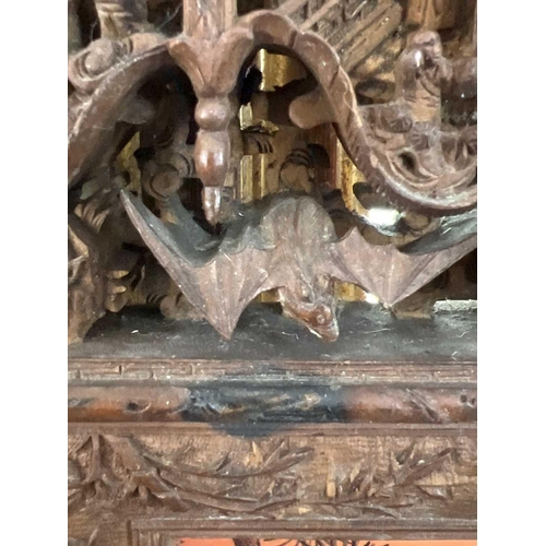 124 - A Chinese carved wood photo frame, early 20th century. Carved with dragons, birds, animals, pagodas ... 