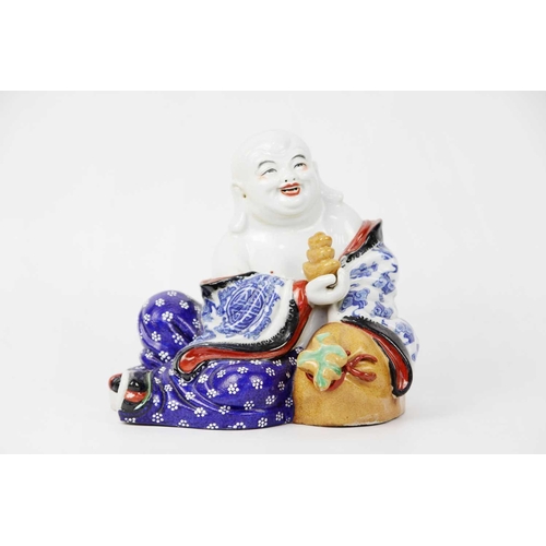 129 - A Chinese porcelain model of a seated Buddha, mid 20th century. Seal mark to base, height 16cm, widt... 