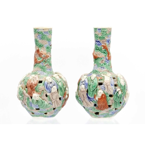 133 - A pair of Chinese famille verte reticulated bottle vases, Qing Dynasty, 19th century. The body mould... 