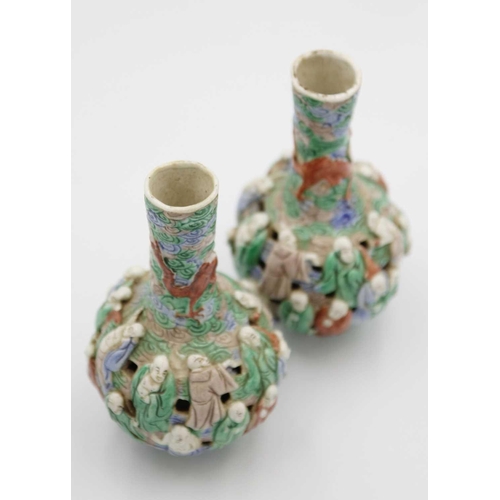 133 - A pair of Chinese famille verte reticulated bottle vases, Qing Dynasty, 19th century. The body mould... 