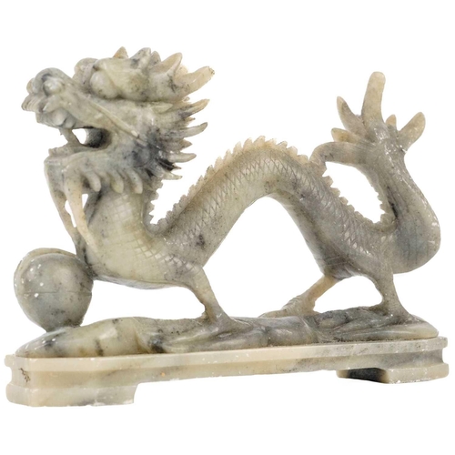 134 - Seven Chinese soapstone carvings and figures, 20th century. Including a pair of seated lion dogs, he... 