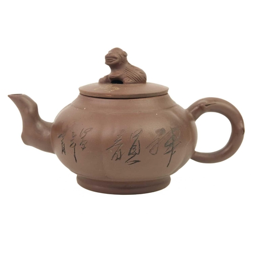 138 - A Chinese Yixing pottery teapot. Large seal mark to base, the body with incised decoration of a bird... 