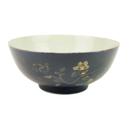 164 - A Chinese blue-ground porcelain punch bowl, Qianlong period. Painted to the exterior in gilding with... 