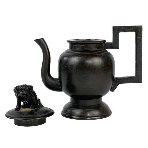 169 - A Chinese bronze and silver inlaid teapot, 19th century. The cover mounted with dog of fo, the ovoid... 