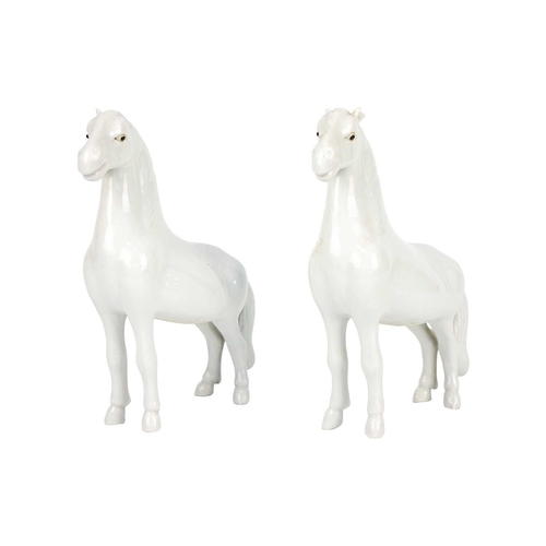 218 - A pair of Chinese porcelain models of horses, possibly 18th/19th century. Height 16.5cm, width 13.5c... 