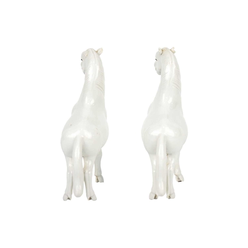 218 - A pair of Chinese porcelain models of horses, possibly 18th/19th century. Height 16.5cm, width 13.5c... 