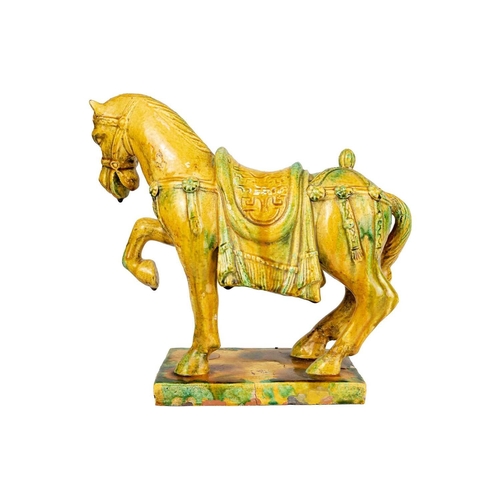 231 - A Chinese Tang style Sancai glazed model of a horse. Height 31cm, width 34cm, depth 15cm.