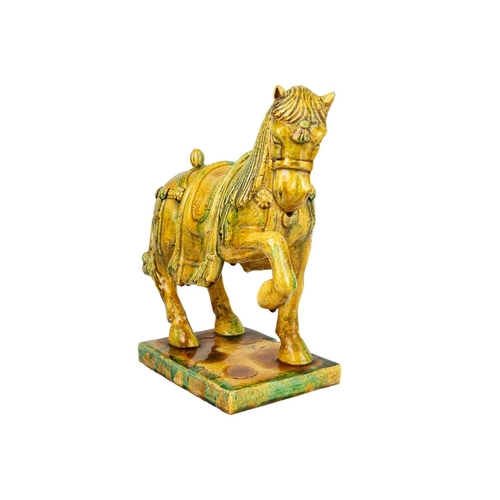 231 - A Chinese Tang style Sancai glazed model of a horse. Height 31cm, width 34cm, depth 15cm.