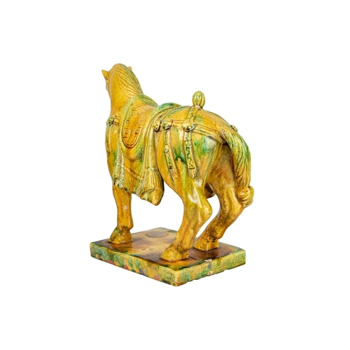 231 - A Chinese Tang style Sancai glazed model of a horse. Height 31cm, width 34cm, depth 15cm.