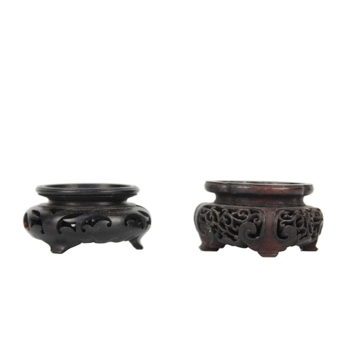 237 - Eight Chinese carved wood vase stands. Largest inner diameter 15cm and a folding plate stand. (9)