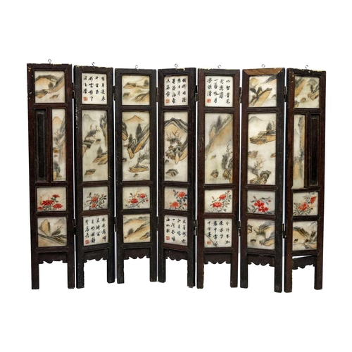 24 - A Chinese alabaster and hardwood seven paneled screen, Qing Dynasty, late 19th century. Painted with... 