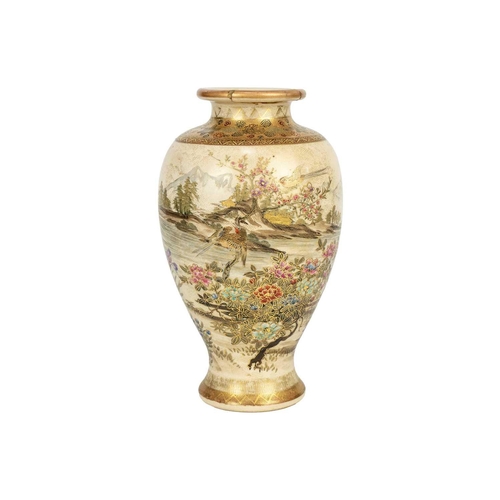 255 - A Japanese Satsuma vase, Meiji period. Gilt decorated with flowering trees and birds in a mountainou... 